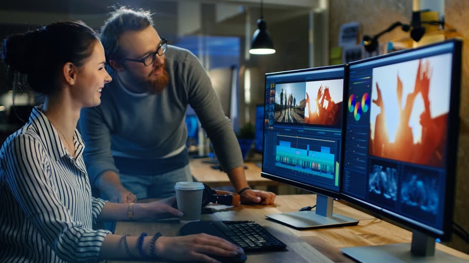 Colorist showing her editing suite to a coworker