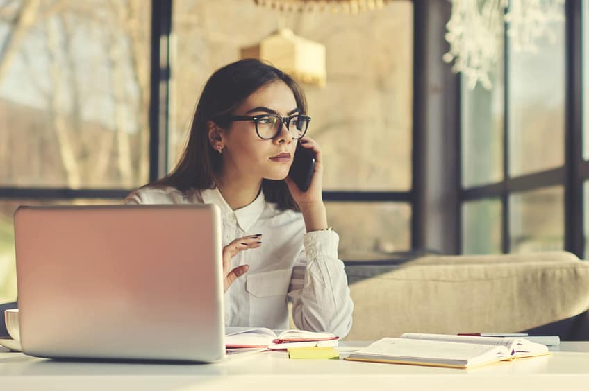 Producer talking on her phone in her office