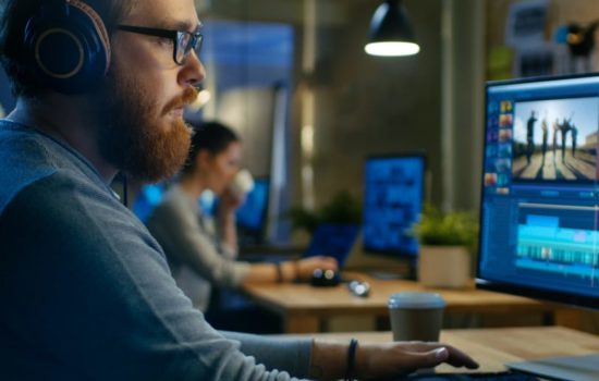Film Editor working in editing suite