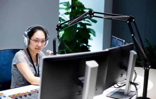 Foley Engineer with headphones on in her editing suite