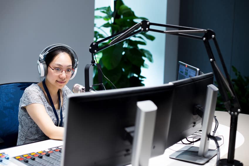 Foley Engineer with headphones on in her editing suite