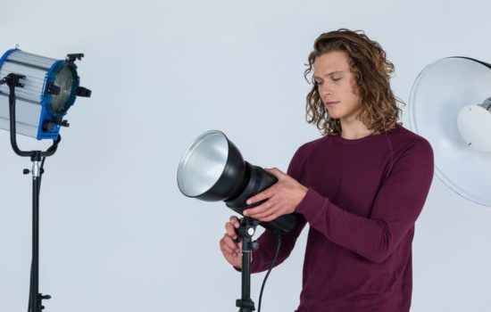 Gaffer aiming light on set