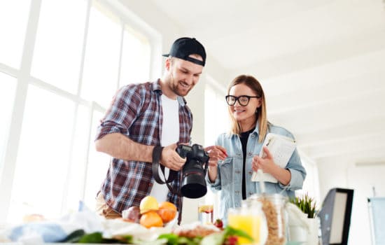 Production Assistant looking at footage on camera