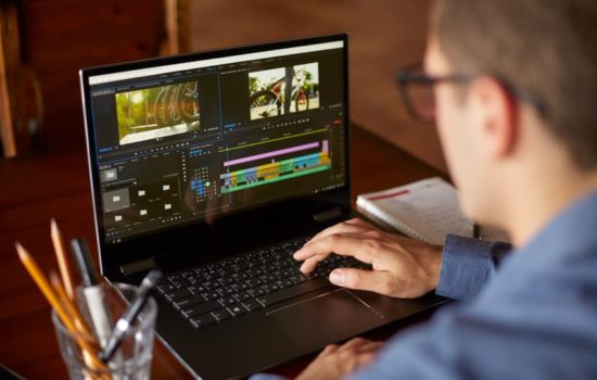 Digital Imaging Technician looking at footage on his laptop