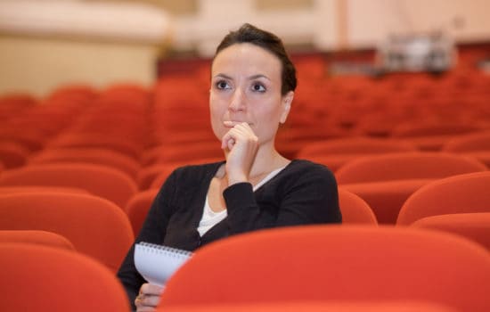 Casting associate sitting in empty theatre
