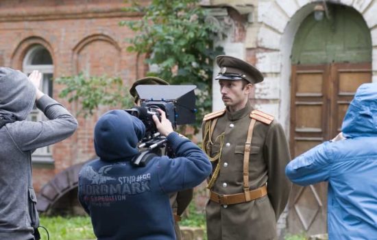 Extra dressed as a soldier being filmed by camera crew