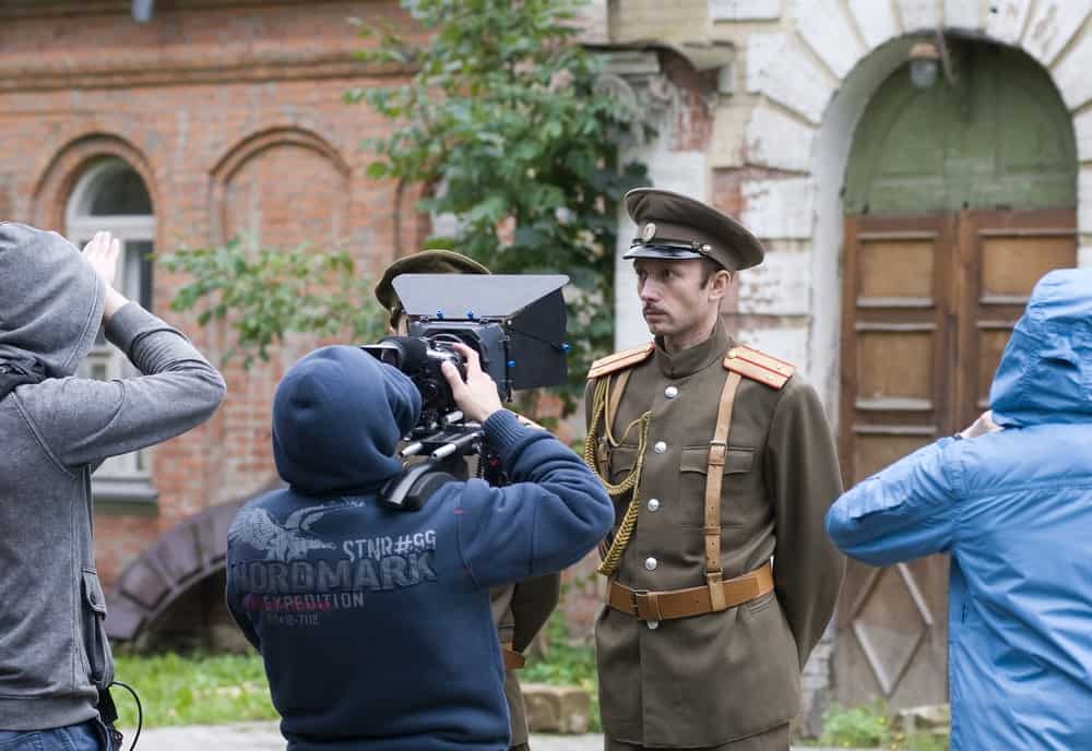 Extra dressed as a soldier being filmed by camera crew