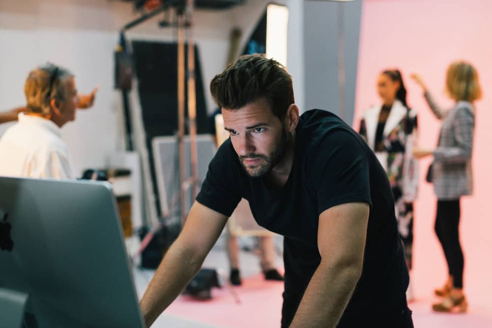 Movie producer watching playback on set