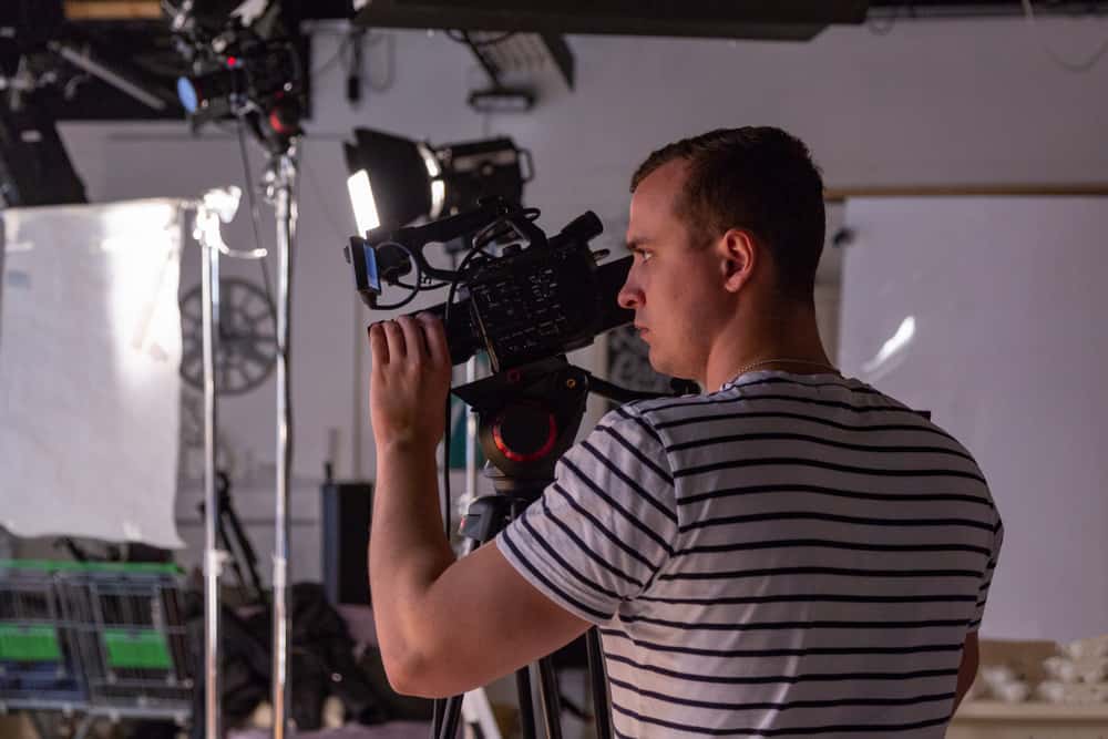 Male camera operator on film set