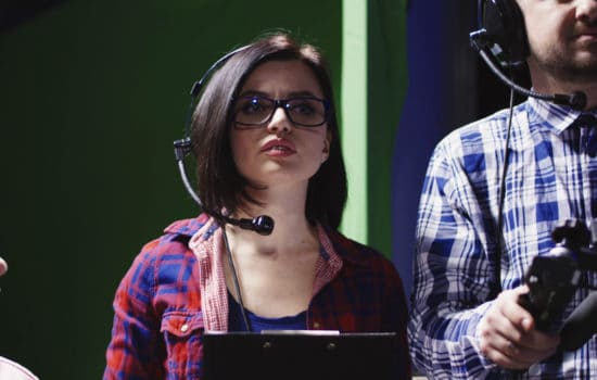 Associate producer wearing headphones on set