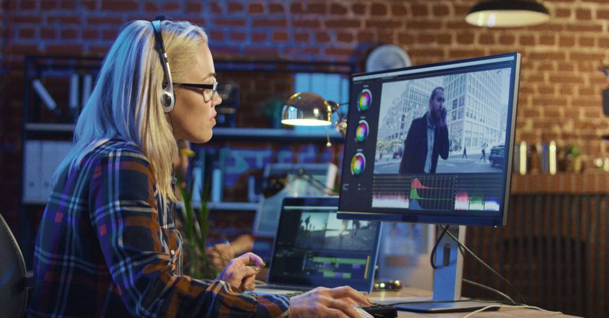 Blonde Asian woman working on post-production color effects on her computer