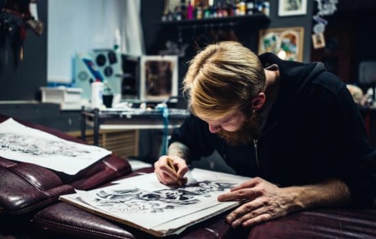 Storyboard artist sketching a large panel