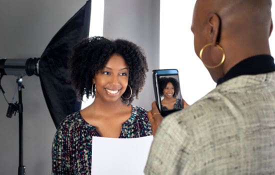 Casting assistant taking a snapshot of an actress in casting office