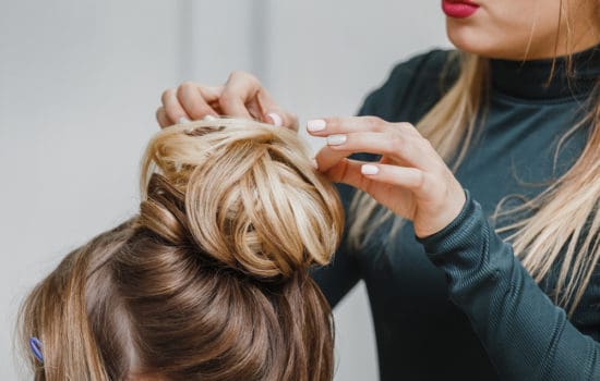 Hairdresser fixing an actress' hair