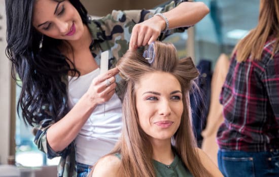 Key Hair Stylist curling an actress' hair