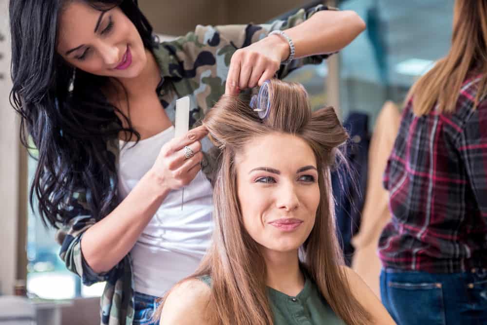 Key Hair Stylist curling an actress' hair