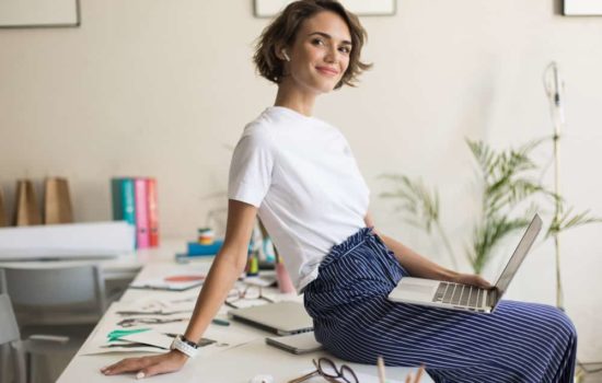 Assistant Production Coordinator sitting on her desk in her office