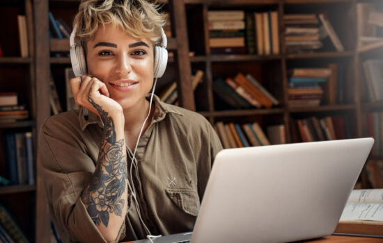 Female Screenwriter formatting a screenplay on her laptop