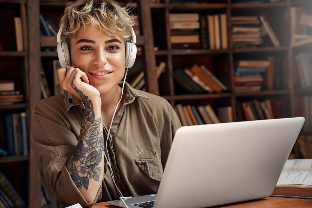 Female Screenwriter formatting a screenplay on her laptop