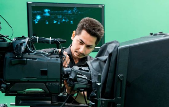 Visual Effects Supervisor looking at a camera on a set with a green screen