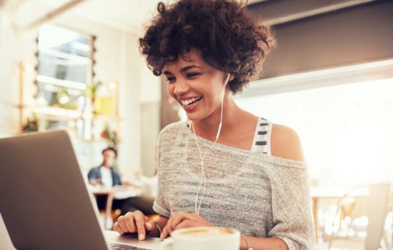 Script Reader smiling and reading script on her laptop
