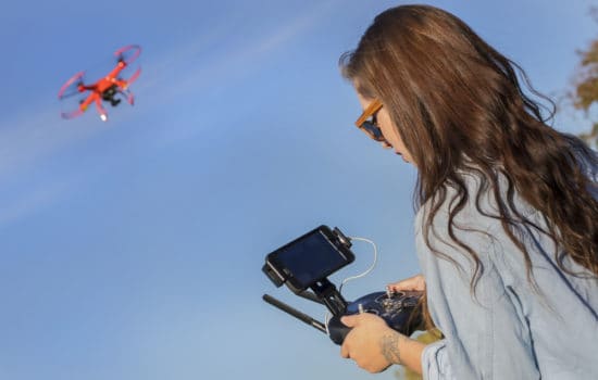 Drone Operator piloting her drone through the sky