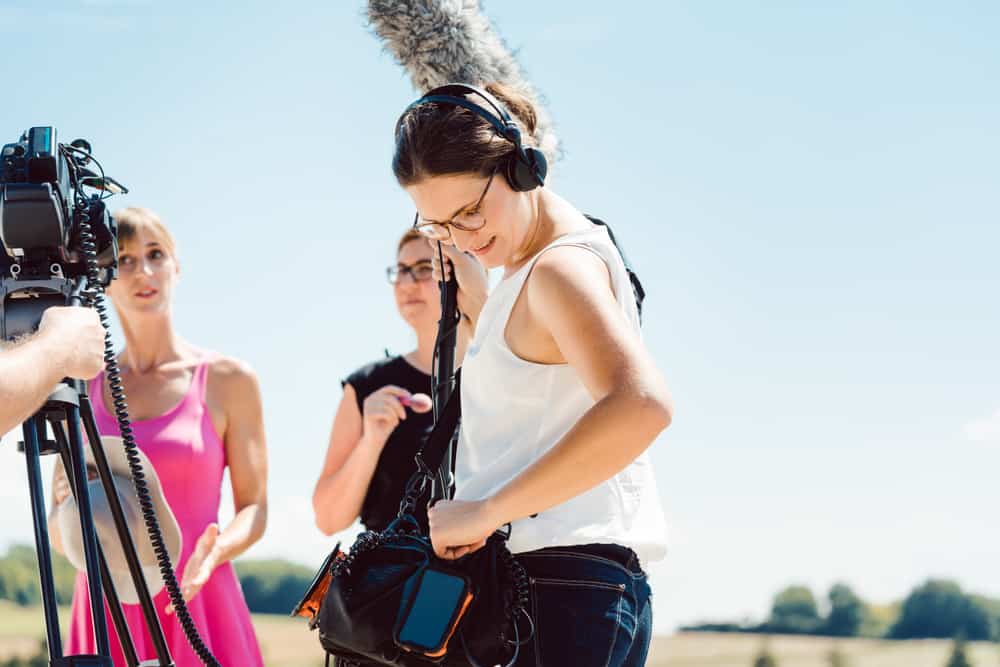 Female boom operator making a movie with other female crew
