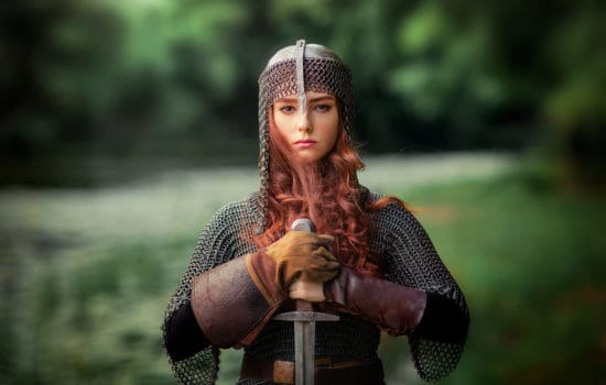Actress dressed as a medieval warrior with sword