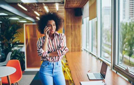 Post-production Coordinator talking on her phone at her office