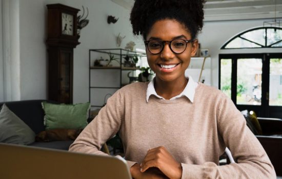 Black female Screenwriter writing at home